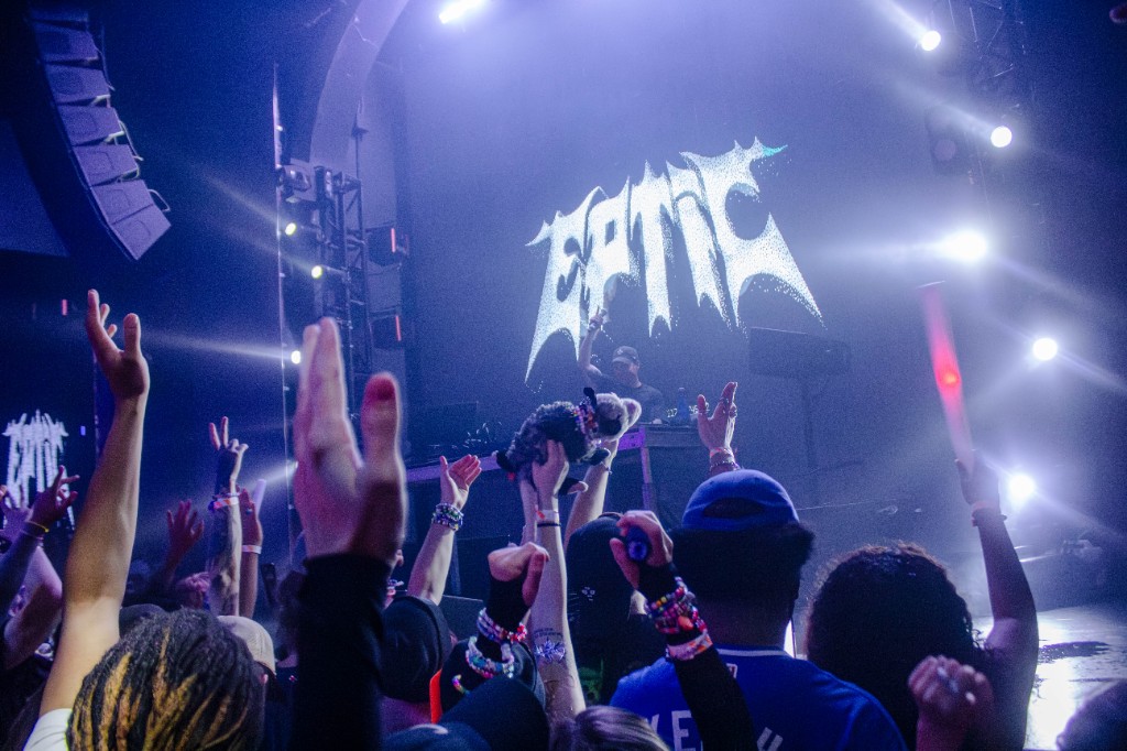 Crowd reaching toward EPTIC on the LED wall