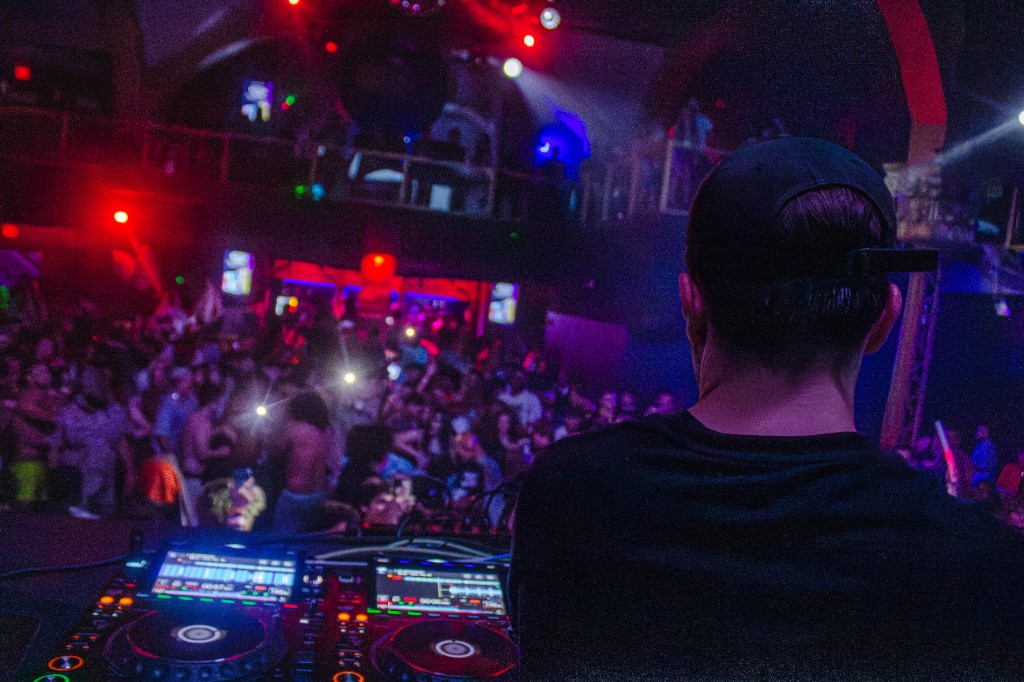 From the booth looking out — Pioneer decks, magenta wash