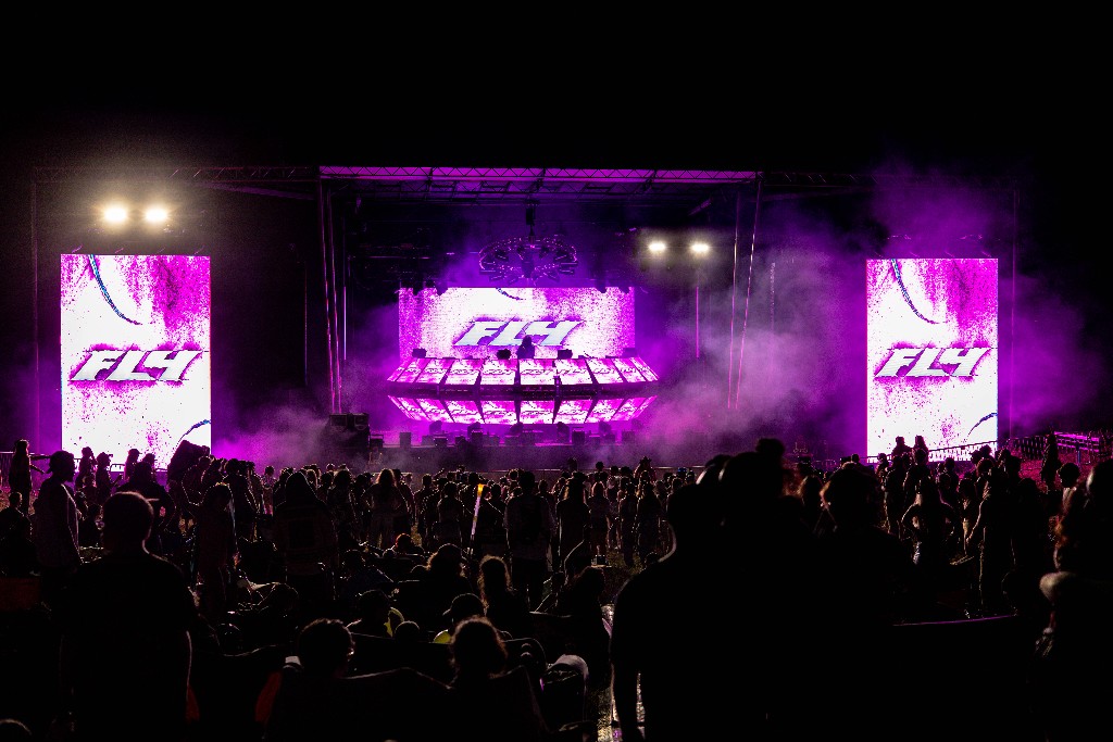 FLY stage — magenta production, LED screens, crowd at Sound Haven