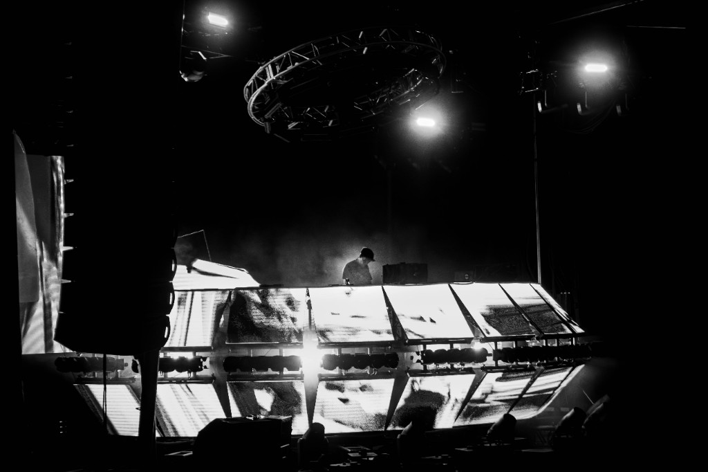 G Jones silhouetted between LED panel structures