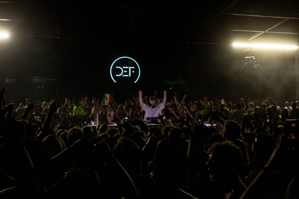 It's Murph arms up, DEF neon behind him