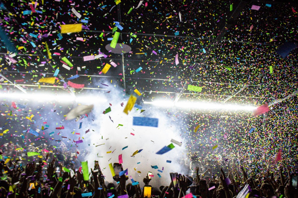 Confetti and haze over raised hands