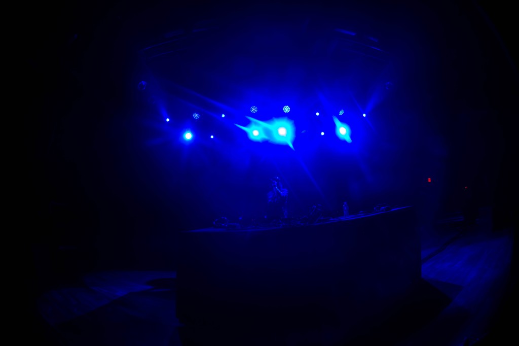Truth silhouetted under blue spots, Terminal West