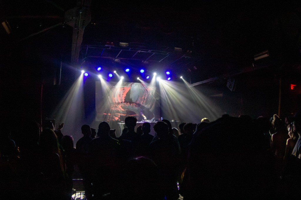 Crowd facing white beams and LED visuals
