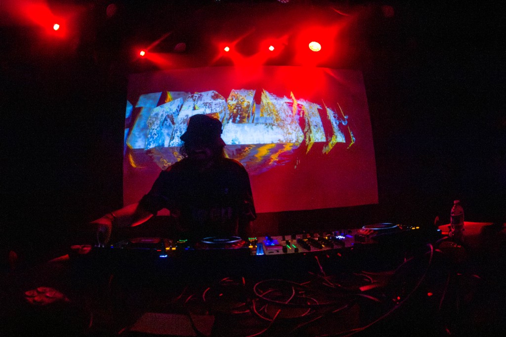 TRUTH on the LED wall, Pioneer decks in the foreground